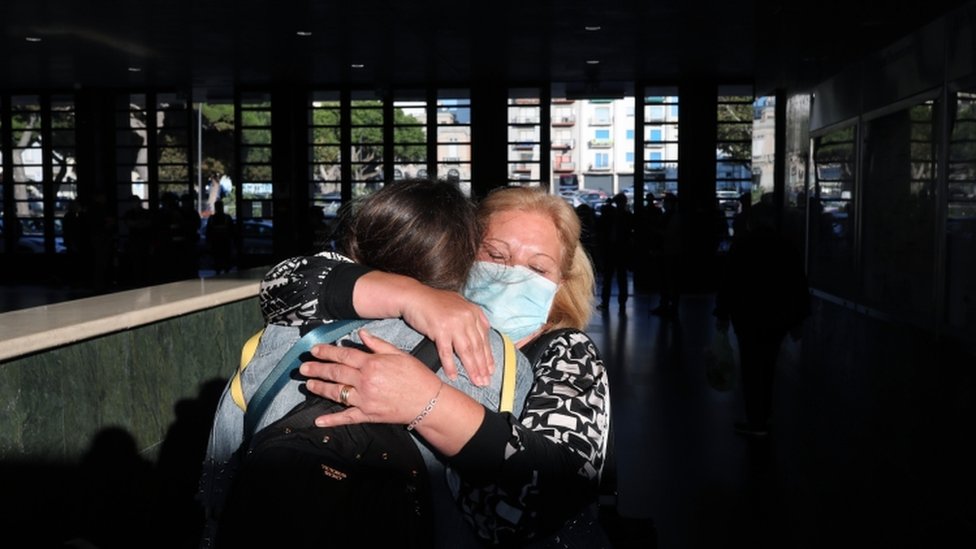 A mother and daughter embrace after the arrival of the first high-speed train connecting Turin and Reggio Calabria