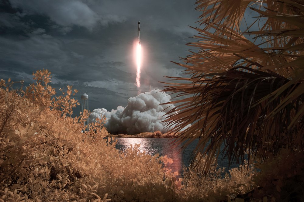 SpaceX Falcon 9 rocket carrying the Crew Dragon spacecraft launches in the distance