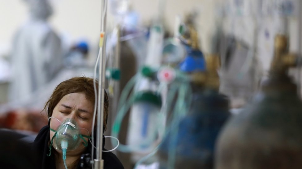 An Afghan woman breaths through an Oxygen mask in Afghan-Japan special hospital for Covid-19 patients in Kabul