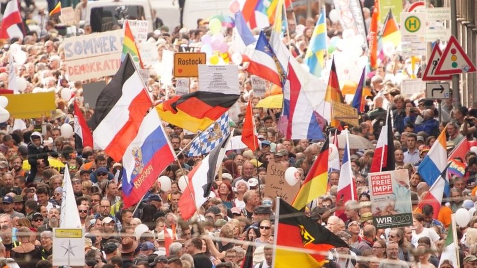 Demonstrators with various flags of Germany, Russia, Netherlands, German Empire and Bavaria protest against coronavirus pandemic regulations in Berlin, Germany, 29 August 2020.
