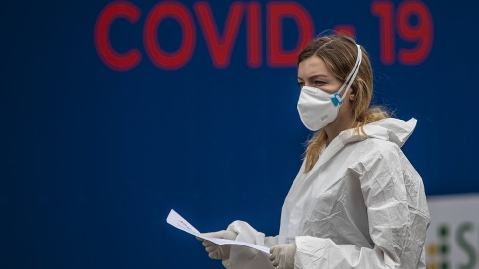 A masked health worker stands near a Covid-19 testing centre in Prague, Czech Republic on 17 September