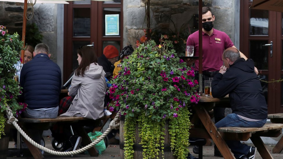 People drinking outside a pub