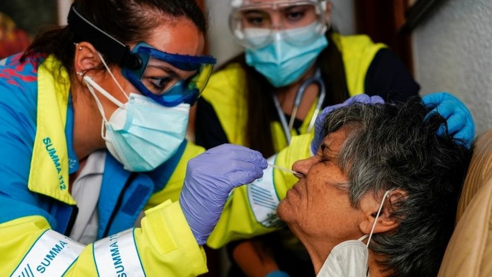 Korona virus: Očekuje se i više od hiljadu zaraženih dnevno u Srbiji, Kina testira ceo grad 2 A medic tests an elderly woman for Covid-19 in Madrid
