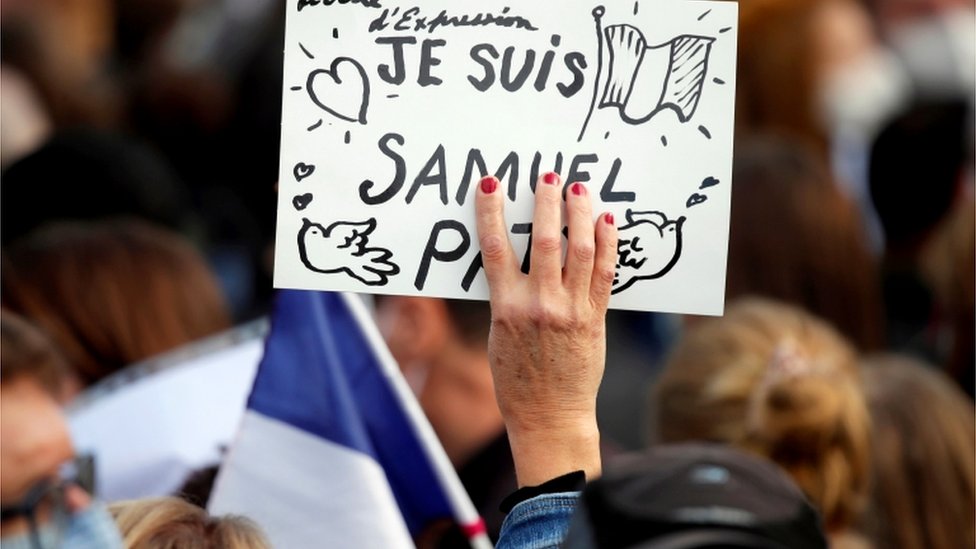 People gather at the Place de la Republique in Paris, to pay tribute to Samuel Paty, the French teacher who was beheaded