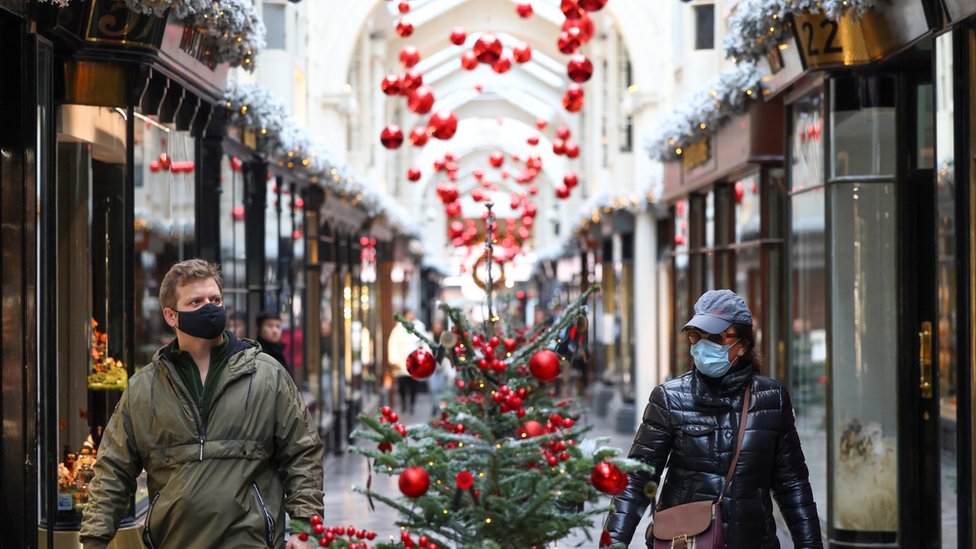 People walk through the Burlington Arcade adorned with Christmas decorations