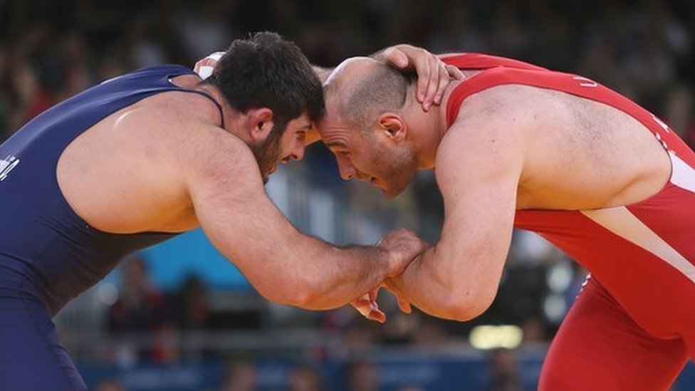 Uzbekistan's Artur Taymazov (R) wrestles Georgia's Davit Modzmanashvili in their Men's 120kg gold medal match at the London Olympics