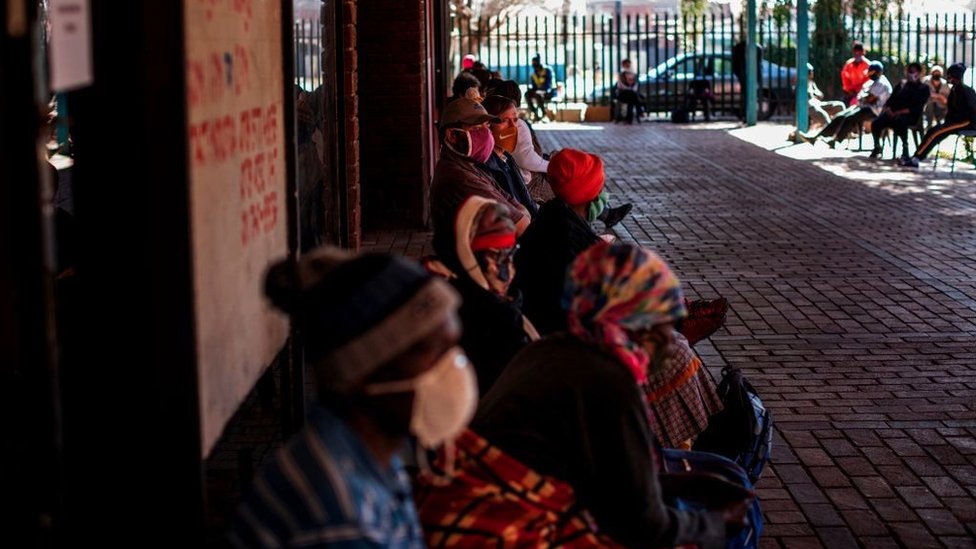 People queue to receive food parcels distributed by Meals on Wheels in Brapkan, South Africa, on July 6, 2020.