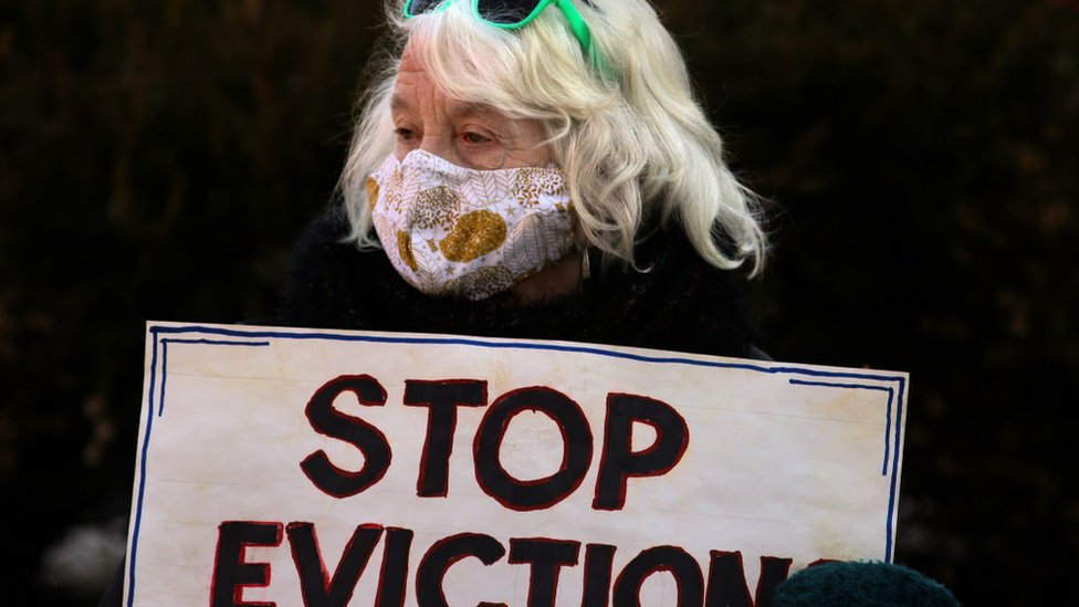 A demonstrator carried a simple message. Boston tenants, faith leaders, and small landlords rallied and marched, calling for a stronger, longer federal eviction ban