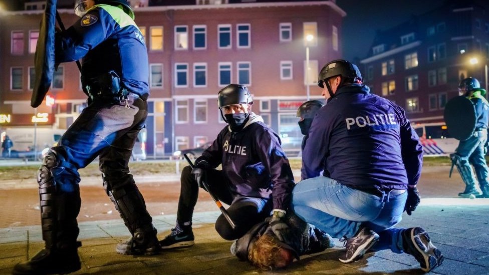 Dutch policemen arrest a man during clashes with a large group of young people on Beijerlandselaan in Rotterdam