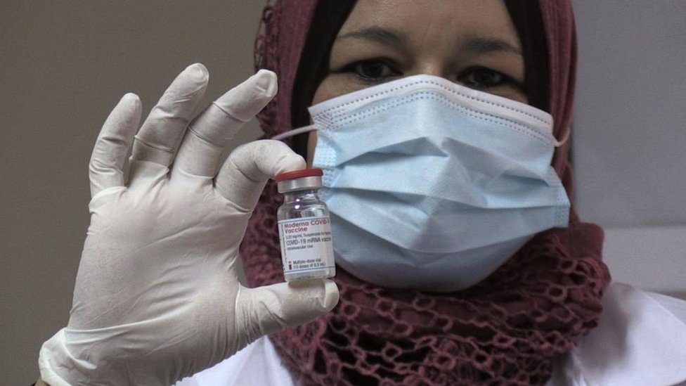 A nurse in Bethlehem, West Bank holding a dose of the Moderna vaccine being used there for healthcare workers.