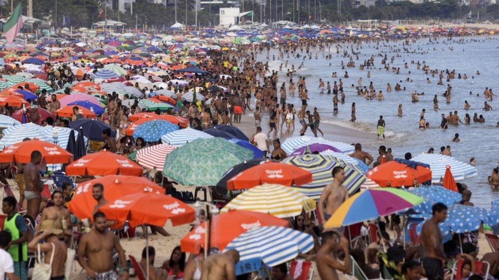 Beach-goers crowding on a beach in Rio de Janeiro in February 2021