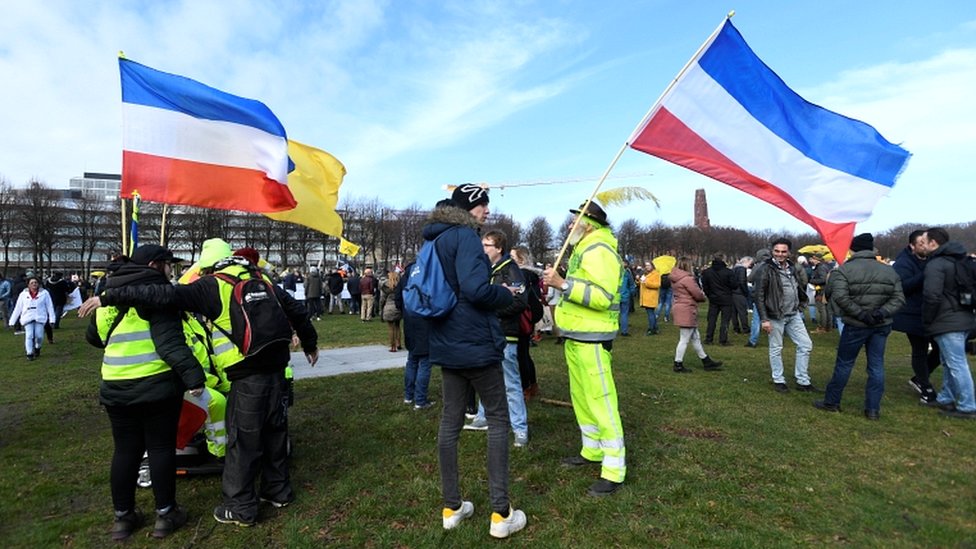 People protest against the Covid-19 restrictions in The Hague, Netherlands, on 14 March 2021