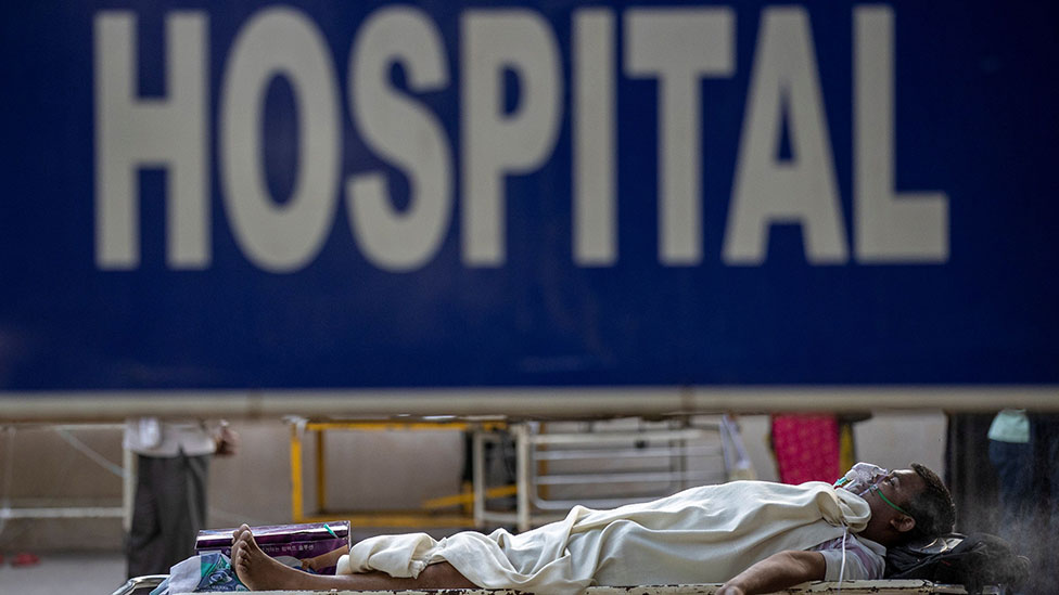 Patient outside a hospital in India