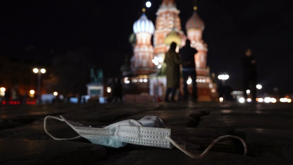 A discarded protective face mask lies on the Red Square in Moscow, Russia, 27 March 2021