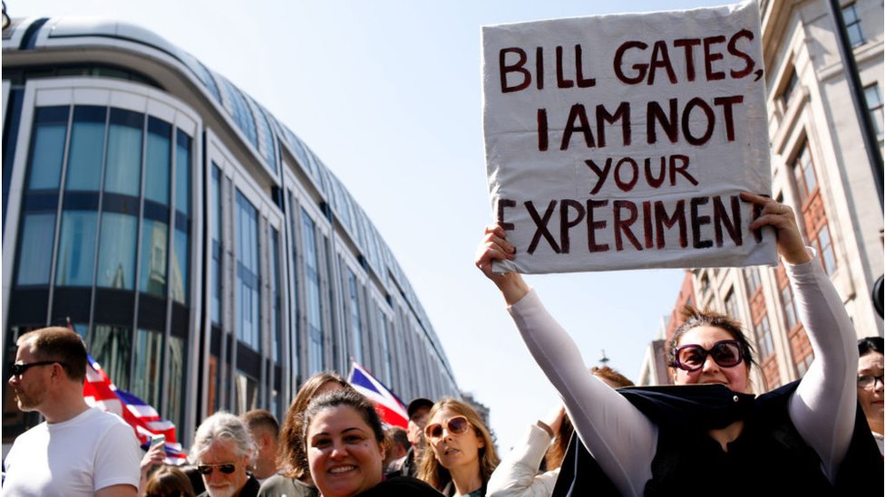 Korona virus, teorije zavere i društvene mreže: Dobrovoljci koriste „mamac“ grupe za borbu protiv antivakcinalne propagande 5 Woman holds sign about Bill gates at protest