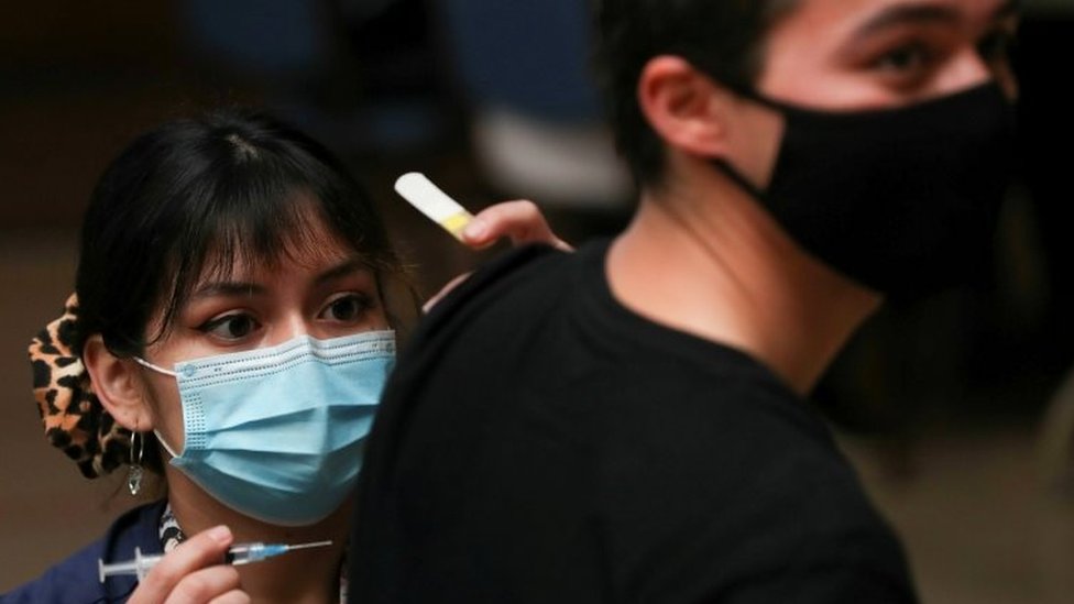 A healthcare worker prepares to vaccinate a man in Santiago, Chile. File photo