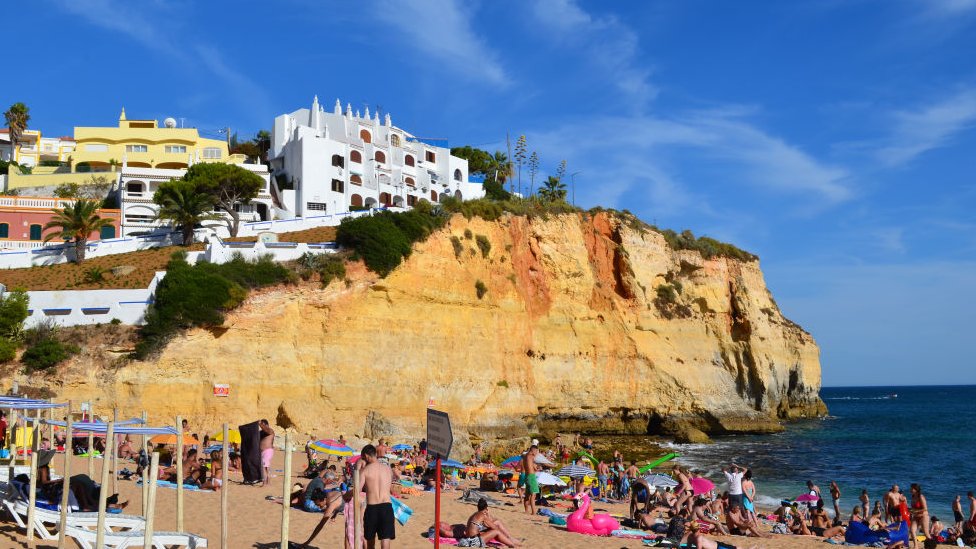 Tourists in the beach in Carvoeiro, Algarve, Portugal