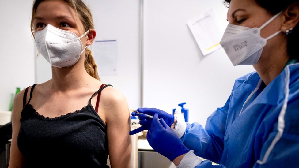 A young women is vaccinated against the coronavirus in Vienna, Austria, 2 April 2021