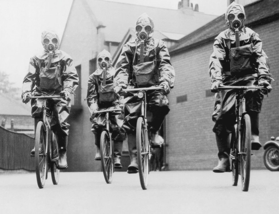 Cyclists of the London police unit wearing gas masks
