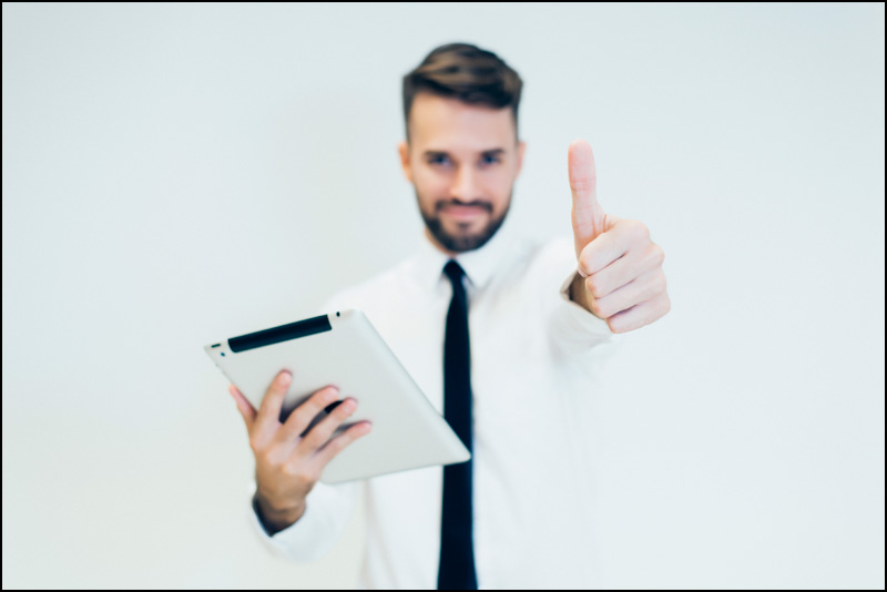 man with tablet thumbs up